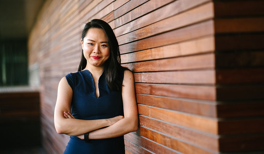 business woman by wooden wall